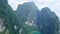 Aerial view of limestone rocks rising from water. Top view of mountains in Khao Sok National Park on Cheow Lan Lake