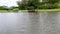 Aerial view of little wood cabana next the lake in the valley, with family enjoying relax moment