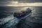 Aerial view of a loaded container cargo ship as it speeds over the ocean.