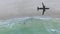 Aerial View of lonely beach with shadow of airplane