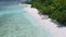 Aerial view of lonely tourist boat moored at tropical exotic beach. Blue lagoon with clear blue ocean water and lush