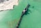 Aerial view of the long boom of a suction excavator in a quartz quarry for the excavation of white sand.