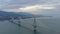 Aerial view of long cable-stayed Rio bridge in Greece at clouds weather, Ferry station