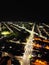 Aerial view of long illuminated highway stretching through urban area