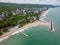 Aerial view of a long pier extending into the sea, located at a hotel's beachfront, perfect for romantic walks and