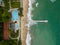 Aerial view of a long pier extending into the sea, located at a hotel's beachfront, perfect for romantic walks and