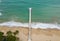 Aerial view of a long pier extending into the sea, located at a hotel's beachfront, perfect for romantic walks and