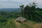 Aerial view of a lookout point with a small hut with a leaf roof that has a view over tropical rainforest