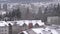 Aerial view of low rise apartment and house on mountain during cold blizzard snow