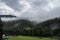 Aerial view of lush green Horni Lomna with foggy green forests in the background