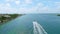 Aerial view of luxurious private yacht cruising around crystal clear waters of South Pointe Beach and Fisher Island and