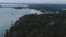 Aerial view of luxury hotel surrounded by trees and next to the ocean and blue turquoise water. Shot. Luxurious villa