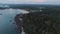 Aerial view of luxury hotel surrounded by trees and next to the ocean and blue turquoise water. Shot. Luxurious villa