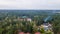 Aerial view of luxury hotel with villas in forest. Luxurious villa, pavilion in forest. Resort complex in forest surrounded by