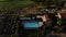 Aerial view: luxury house in the nature with swimming pool at sunset