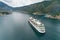 Aerial view of luxury medium cruise ship sailing to port through the bay