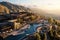 An aerial view of a luxury resort nestled in the mountains with a sparkling pool