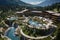 An aerial view of a luxury resort nestled in the mountains with a sparkling pool