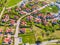 Aerial view of luxury upscale residential neighborhood gated community street real estate with single family homes brick facade