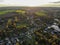 Aerial view of luxury villas & farm surrounded by forest and farmland during  beautiful sunset color.