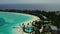 Aerial view of luxury villas over water on blue lagoon