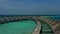 Aerial view of luxury villas over water on blue lagoon