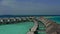 Aerial view of luxury villas over water on blue lagoon