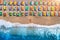 Aerial view of lying woman on the beach with colorful chaise-lounges