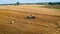 Aerial view of machines for collecting and pressing hay