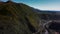 Aerial view of majestic mountains with meandering rivers and rolling hills in lush shades of green