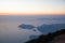 aerial view of majestic seascape and paragliders in sky at sunset,