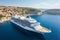 Aerial view of majestic white cruise ship on luxurious ocean expedition, serene sunny day