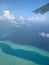 Aerial view of the Maldives in the turquoise water of the Indian Ocean from the porthole of a local airlines plane