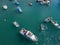 Aerial view of a man in a boat rowing among the boats moored in a harbor