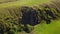 Aerial view of man coming down the mountain. Male hiking down the rocky cliff alone. Climber in the mountains. Guy