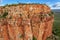 Aerial view of man holding Australian Flag on top of the iconic cliffs and high plateau of the Cockburn Range, El Questro Station