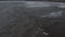 Aerial view of a man on a surfboard moving across waves. Surfer floating on the top of waves in Bali