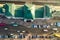 Aerial view of many cars and buses moving on a busy city street in front of railway station building in Ivano-Frankivsk city,