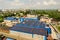 Aerial view of many photo voltaic solar panels mounted of industrial building roof