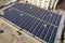 Aerial view of many solar panels mounted of industrial building roof