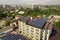 Aerial view of many solar panels mounted of industrial building roof