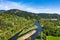 Aerial view of McKenzie River surrounded by lush green on a sunny day