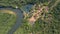 Aerial view of an meandering Amazon tributary river and buildings in the Amazonian rainforest, Mato Grosso, Brazil