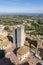 Aerial view of the medieval houses, central sqare and towers of San Gimignano, Italy, and the surrounding landscape