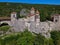 an aerial view of the medieval village in the mountains with some ruins