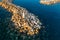 Aerial view of Mediterranean sea and marina or stone pier or breakwater at sunset, drone shot