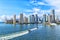 Aerial view of Miami skyscrapers with blue cloudy sky, boat sail