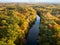 Aerial view of Michigan falls surrounded by forest in a warm autumn glow