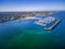 Aerial view of Middle Brighton Marina, coastline, and suburban a