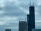 Aerial view of military jet passing Chicago skyscraper